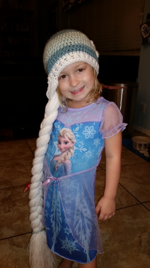Lulu, in an Elsa nightgown, wearing the one and only Elsa hat.  (even when it's 110 degree outside...).